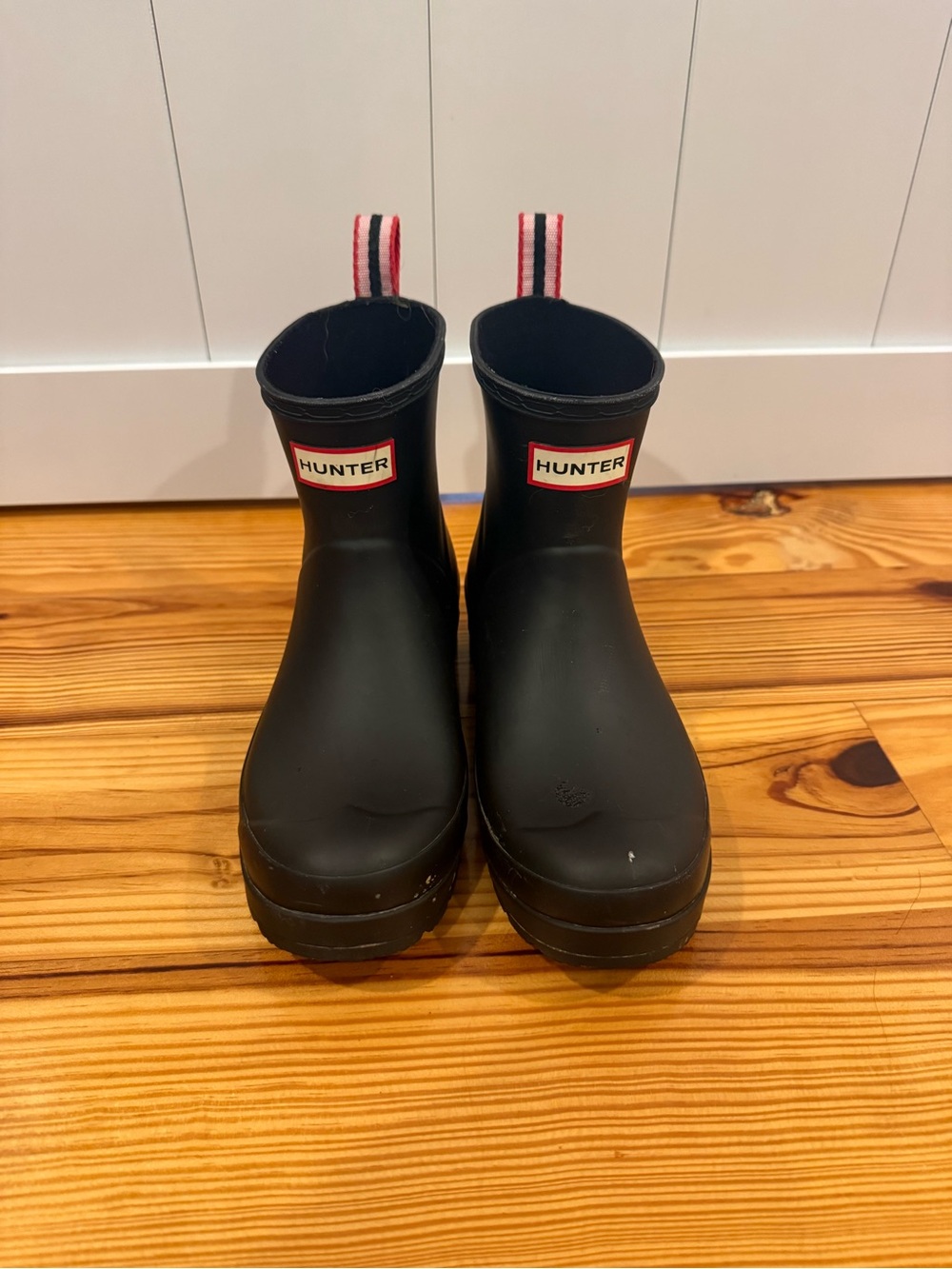 Hunter Black Rain Boots with Red-White Pull Tabs have one spot